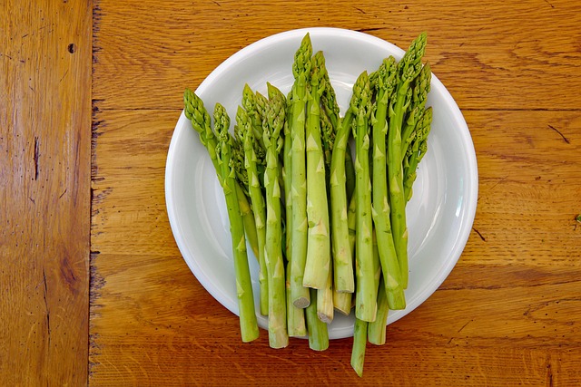 Plato de espárragos verdes frescos, fuente natural de folatos, potasio y antioxidantes esenciales